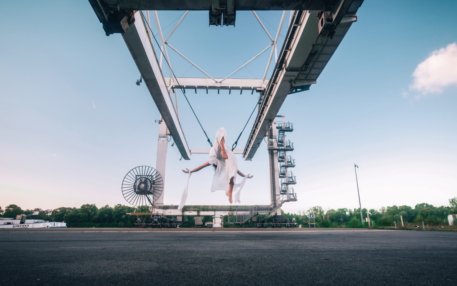 Danseuse aérienne suspendue à un portique du terminal multimodal du Havre.